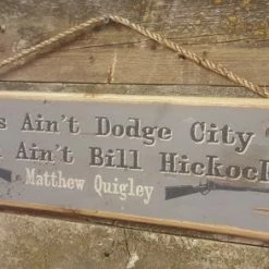 OutWest Shop Decor Wall Sign Movie Quote: Matthew Quigley. This Ain't Dodge City And You Ain't Bill Hickock